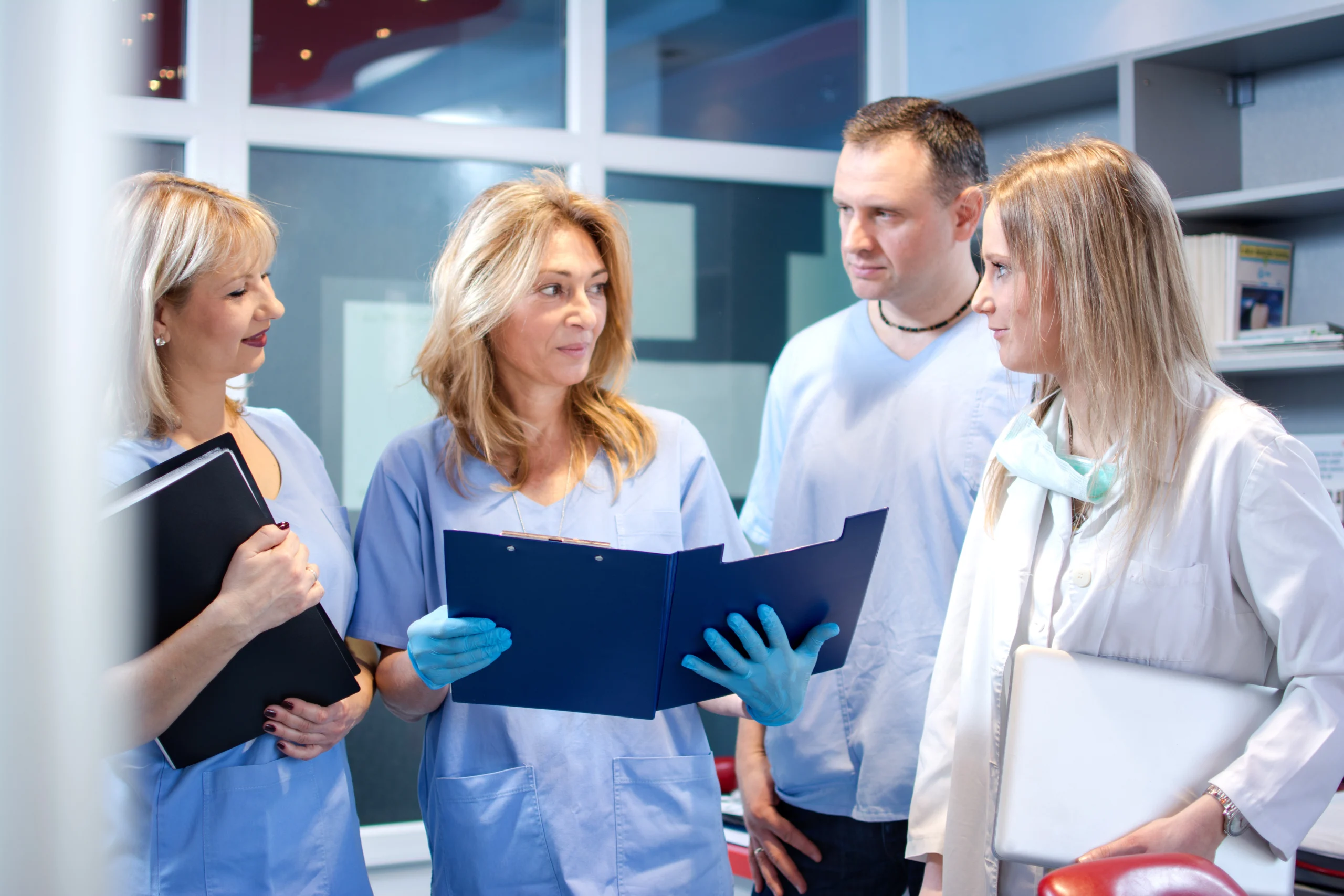 Small team of Doctors examining medical records.
