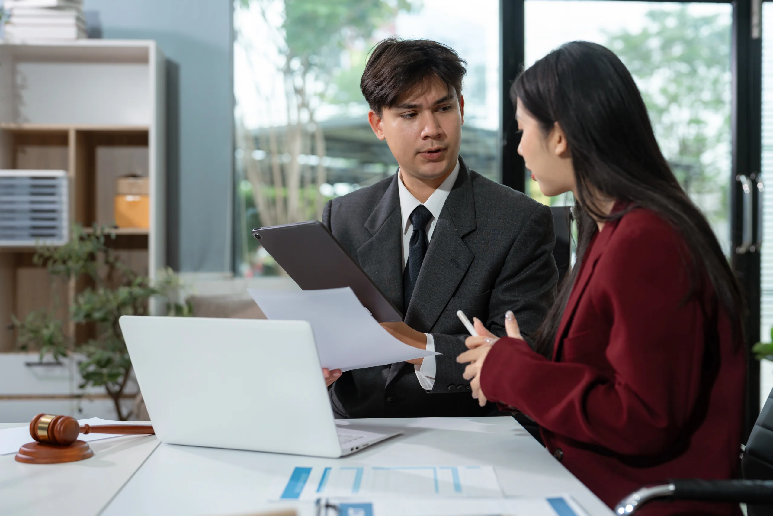 Independent Contractor seated with a Client and analyzing information.