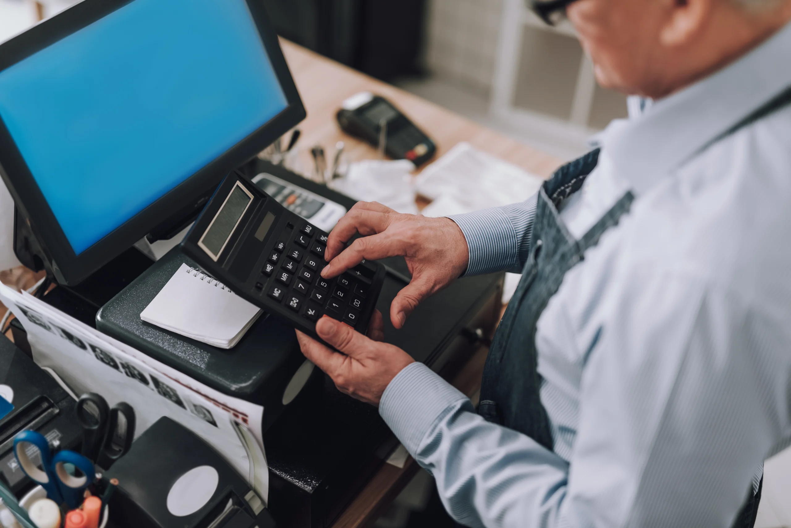 Older Business owner calculating numbers and information