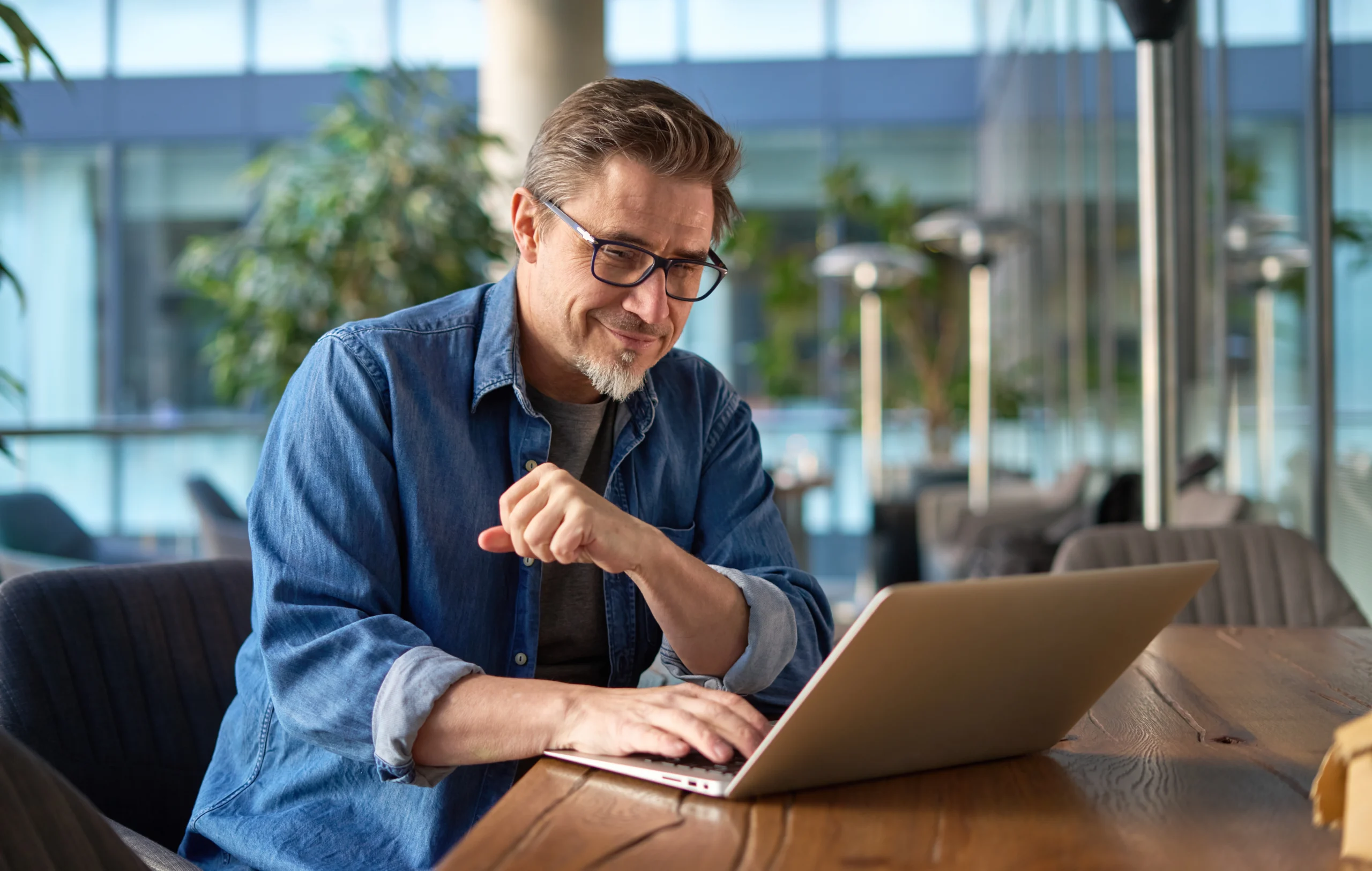 Man looking for RJ Health Partners Coverage on laptop Man looking for RJ Health Partners Coverage on laptop