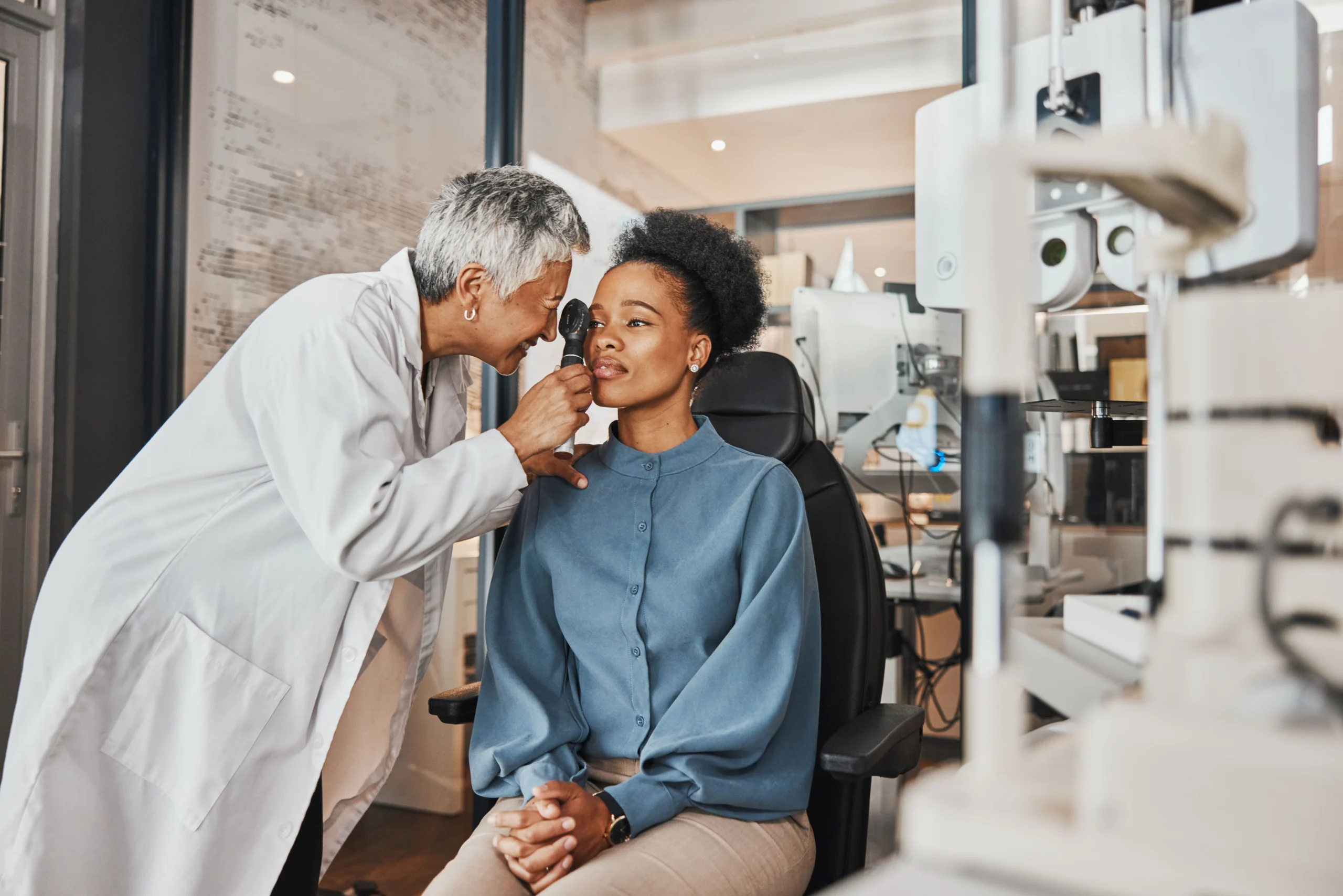 Woman seated for an Eye Exam from an Optician Woman seated for an Eye Exam from an Optician