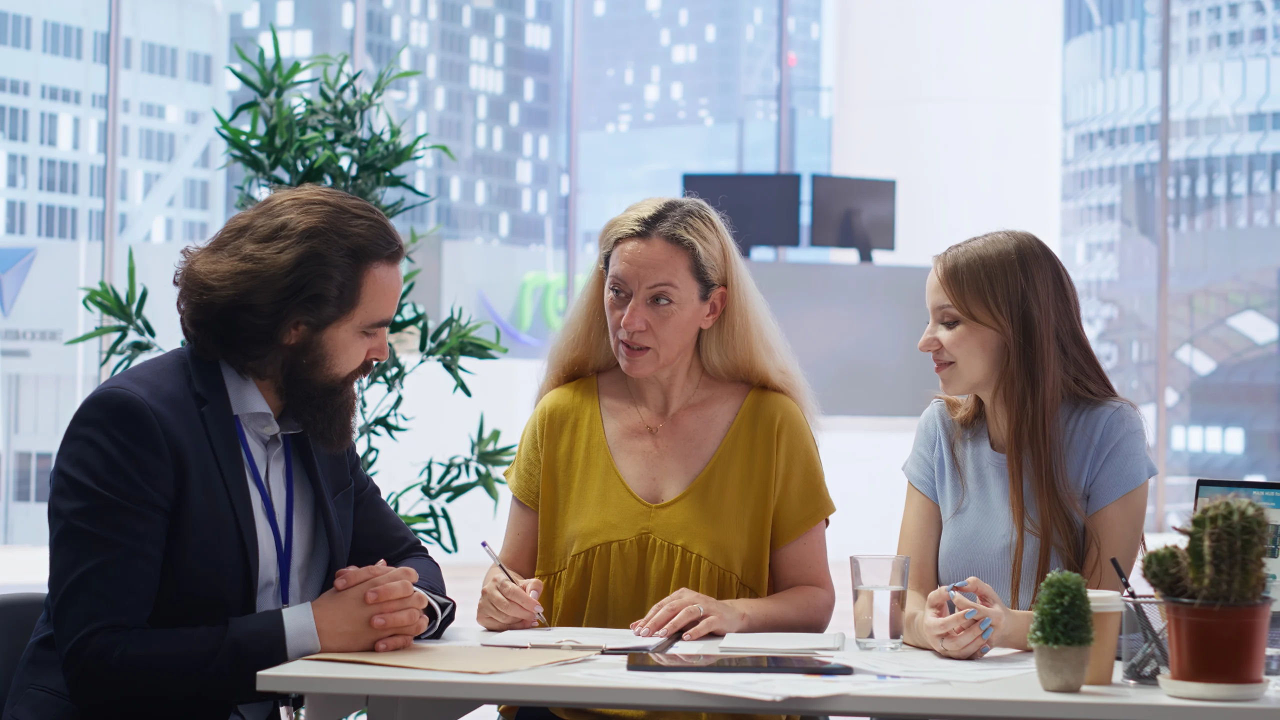 RJ Health Partners Agent in meeting with Woman reviewing Coverage RJ Health Partners Agent in meeting with Woman reviewing Coverage